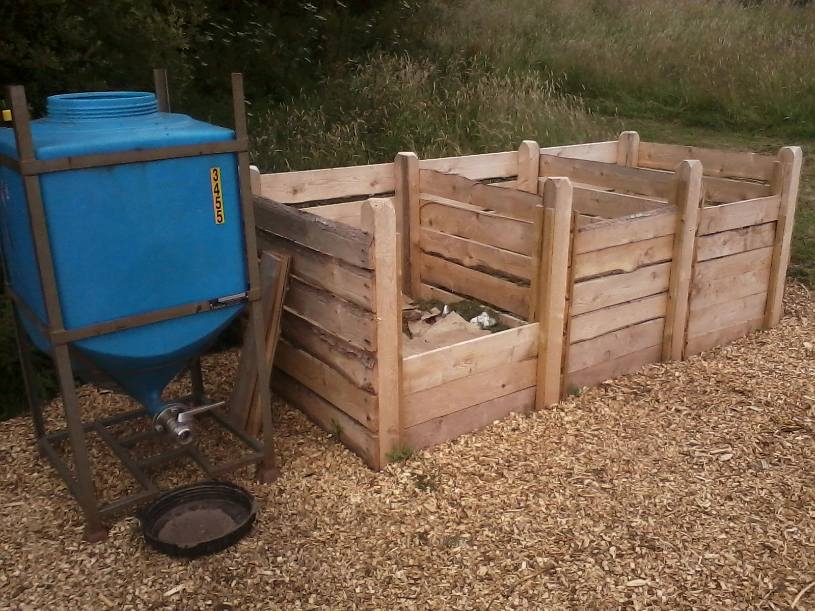 Three wooden compost bins