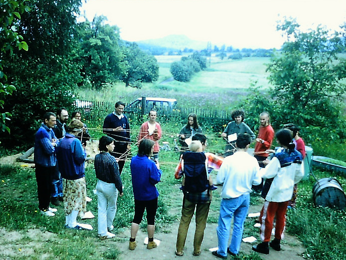 Group of people in a field discussing disaster planning