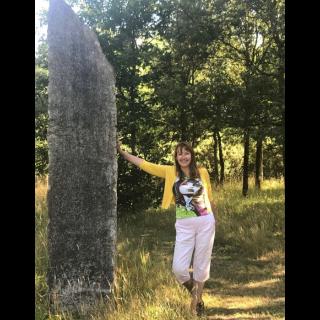 karen noon standing next to a menhir